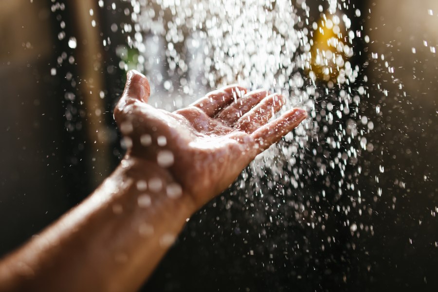 A hand being doused in water treated by a water softener in San Antonio