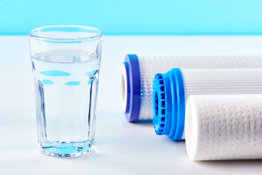 Different Types of Water Filters next to a glass of water