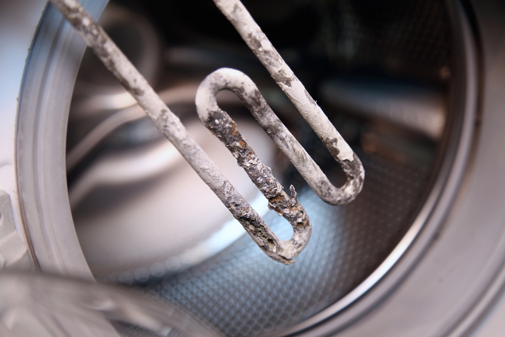Limescale buildup caused by hard water on a water heater heating element, showing the effects of high grains per gallon water hardness in San Antonio, Texas.