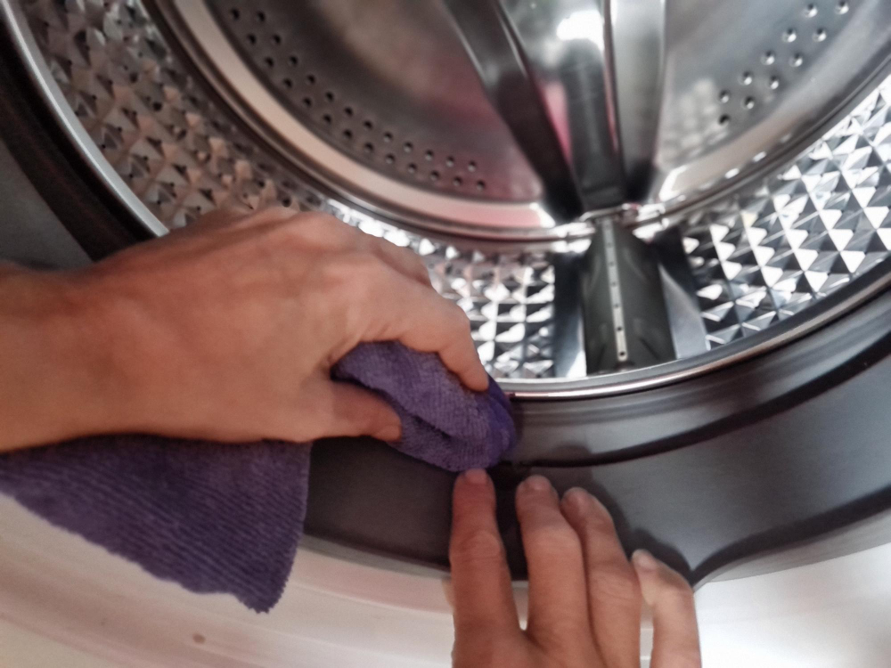 Hard water scale buildup inside a washing machine, a common sign that water softener repair or service may be needed in San Antonio homes